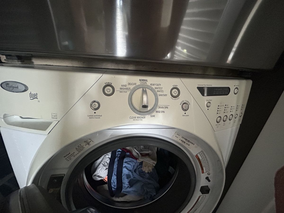 Front-load washer with laundry in the drum before repair