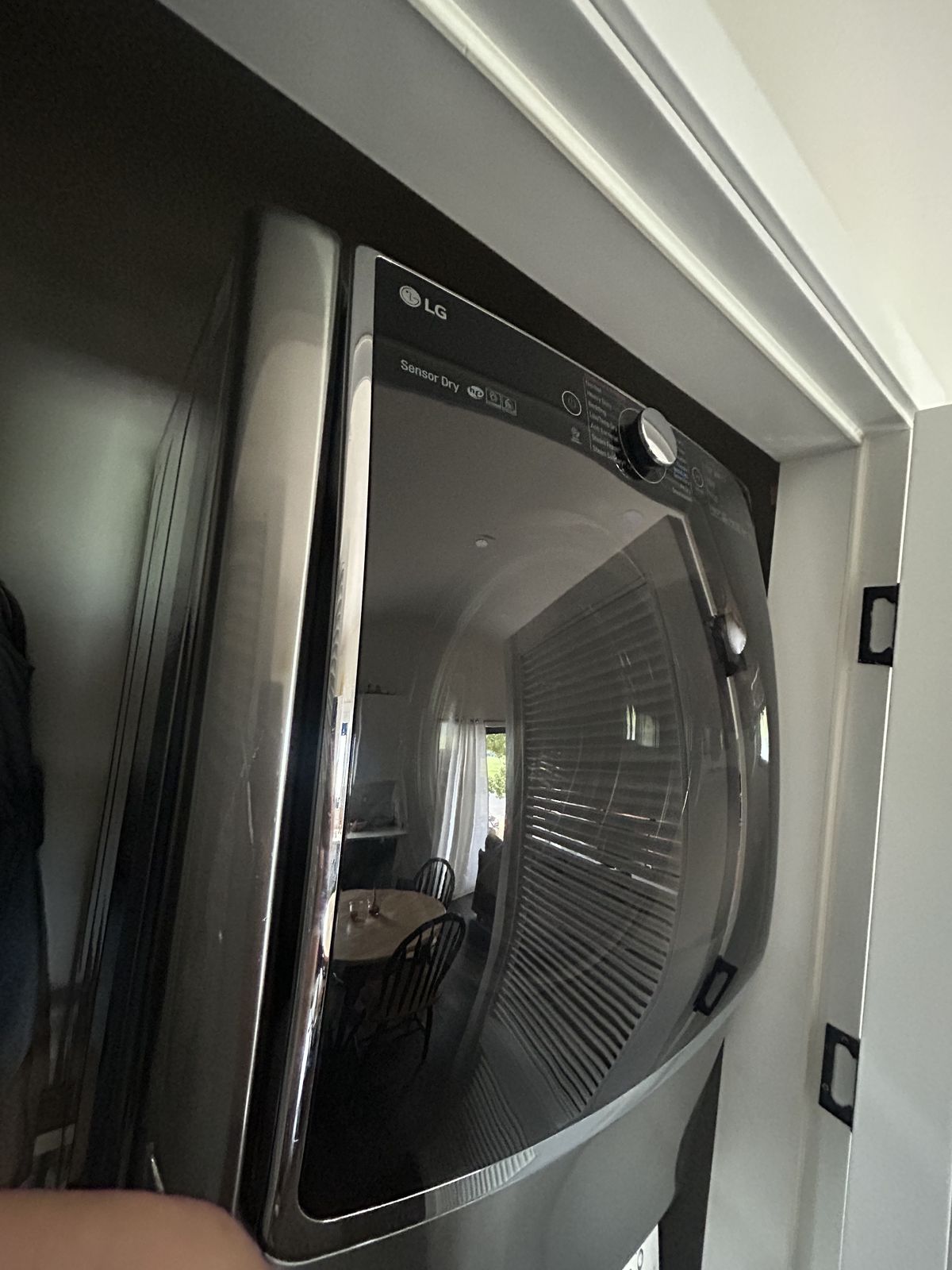 Stacked LG dryer in a laundry closet